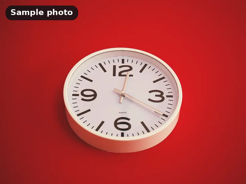 Sample photo: a plain white wall clock on a red background. Not Platinum Prints work.